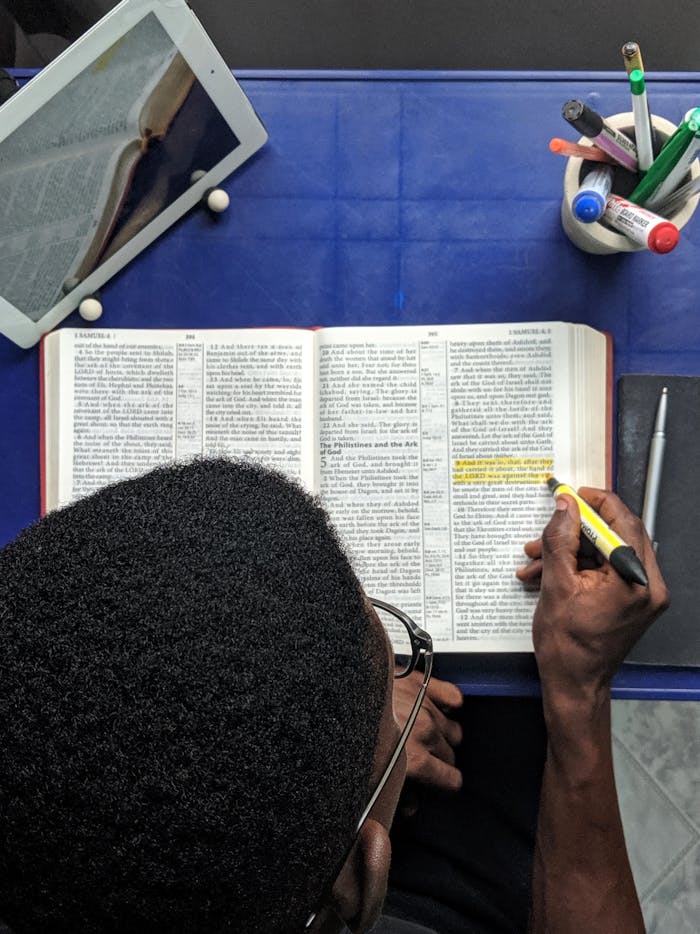 Top View Photo Of Man Reading A Book